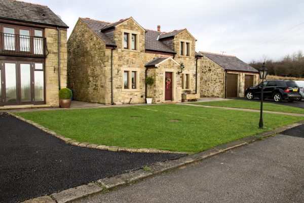 Random stone new build dwelling with detached double garage, Manchester